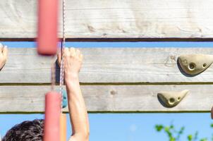 Ninja warrior contestant tackling a hanging obstacle. photo