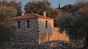 Traditional stone shepherd's house for sale surrounded by olive trees and dry stone walls in the countryside at sunset, creating a peaceful and rustic atmosphere video