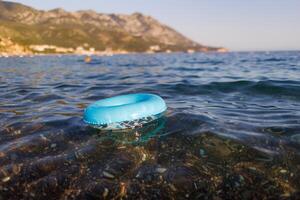 A blue rubber ring floats in the Adriatic SeaBlue rubber ring floats Adriatic SeaBlue rubber ring floats Adriatic SeaBlue rubber ring floats in Adriatic Sea photo