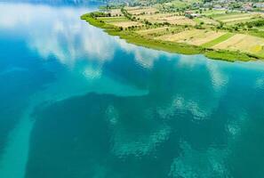 Fields planted with grain crops near Montenegrin villages on the coast of the Adriatic Sea against the backdrop of the Balkan Mountains and sky photo