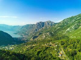 Bay of Kotor with beaches and hotels and the Adriatic Sea against the backdrop of sunny sky photo