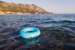 A blue rubber ring floats in the Adriatic SeaBlue rubber ring floats Adriatic SeaBlue rubber ring floats Adriatic SeaBlue rubber ring floats Adriatic Sea photo