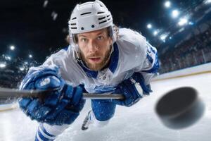 Hockey player sliding on ice during a match, capturing intense game moment photo