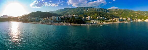 Beach panorama with umbrellas sunbeds relaxing people photo
