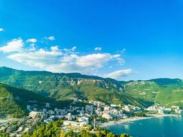 Birds eye view towns Budva Becici hotels beaches Adriatic Sea backdrop Montenegrin Mountains photo