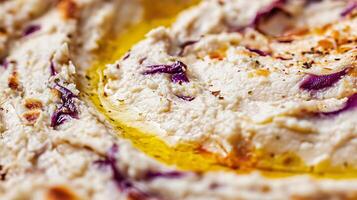 Creamy Hummus Swirl with Olive Oil and Purple Cabbage Close Up. photo
