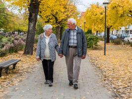 an older couple walking in the park photo