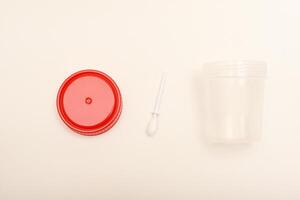 Disposable specimen cup. Jars for urine and fecal tests. Containers for medical tests. photo