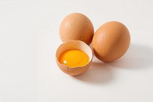 Raw and Cracked Brown Eggs on Clean White Surface photo