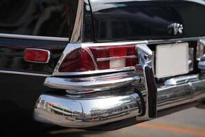 The tail lights, turn signals, and chrome accents on the rear of classic cars exude vintage charm and sophisticated design.d photo