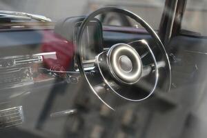 Vintage Classic car steering wheel, with chrome and leather textures in sharp detail, showcases the quality and precision of automotive craftsmanship under natural light.hf photo