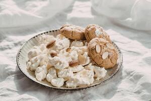 Popcorn with almond cookies on a plate photo