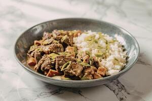 Beef and rice dish with green onions photo