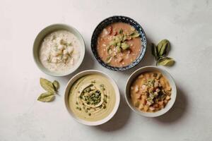 A photograph of four distinct bowls of soup photo