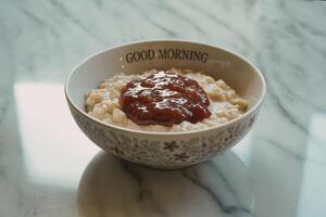 A photograph of a bowl of creamy oatmeal porridge photo