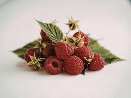 Fresh raspberries and green leaves arrangement photo