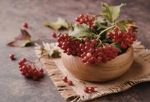 Red berries in a wooden bowl photo