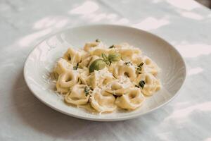 A photograph of a plate of freshly made tortellini pasta photo