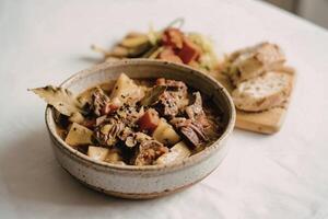 a rustic ceramic bowl filled with hearty stew photo