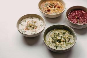 four distinct bowls of soup photo