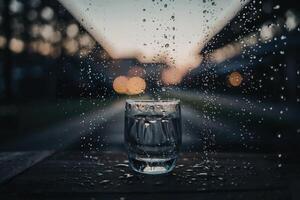 A glass covered with dewdrops with a blurred background - great for background or wallpaper photo