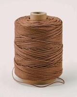 Brown thread spool on white isolated background, packaging rope photo