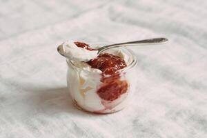 glass jar filled with creamy homemade yogurt photo