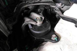 Engine mount or motor mount close-up, engine vibration damper, car part for auto repair, vehicle maintenance. photo