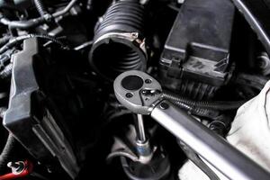 Torque wrench in use, auto repair or car maintenance and engine work with mechanic tool, automotive service. photo