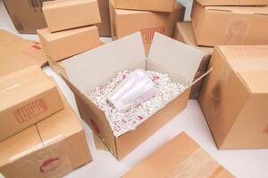 Open shipping box, unboxing or packed a package. Delivery, online shopping e-commerce, moving logistics. photo