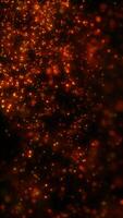 Glowing fiery particles floating in dark space, creating a vibrant and dynamic abstract scene video