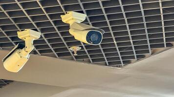 Surveillance cameras lurk with mechanical gaze, embodying a techno dystopian vibe, echoing themes of Privacy Day and Cybersecurity Awareness photo