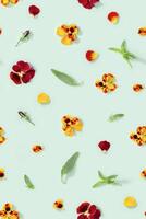 Modern floral seamless pattern with pansy flowers, green leaves and petals, small summer flowery ornament. photo