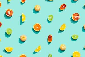 Colorful fruit pattern from fresh citrus, lemon, red orange, tangerine and lime on blue background. Summer food. photo