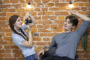 Girl photographer photographs a guy photo