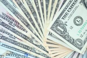 Many dollar bills with nominations lies in big pile photo