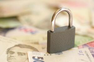 Many ukrainian money bills and small black padlock. photo