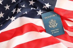 Latest version of United States citizen Passport on USA national flag photo