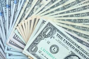 Many different dollar bills lies in big pile photo
