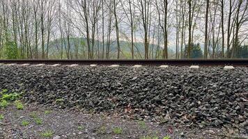 A train track with gravel and trees in the background video