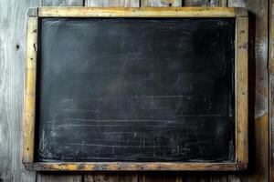 A blank chalkboard against a weathered wood backdrop awaits notes or drawings, brimming with potential and creativity photo