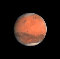 A detailed view of the red planet mars showing its diverse surface and polar ice cap in deep space. photo