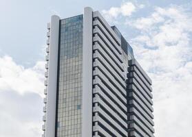Bottom up view office building with blue sky background photo