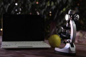 Focus on a microscope standing on a table. photo
