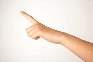 A human hand with extended index finger is isolated on a plain white background, showing a clear pointing gesture. Suitable for concepts involving direction, instruction, navigation, or user interface design. photo