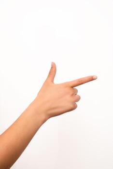 A human hand is making a finger gun gesture, isolated on a plain white background. Suitable for concepts related to communication, direction, or playful gestures in isolated settings. photo