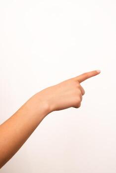 Human hand with extended index finger pointing right, isolated on a plain white background. Suitable for concepts of direction, instruction, or attention in digital or print design. photo