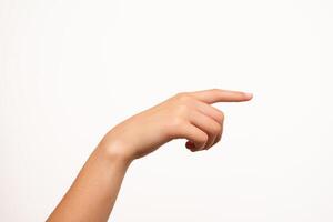 A woman's hand with fair skin is shown pointing with the index finger, isolated on a white background. Suitable for concepts of direction, instruction, navigation, or user interface design. photo