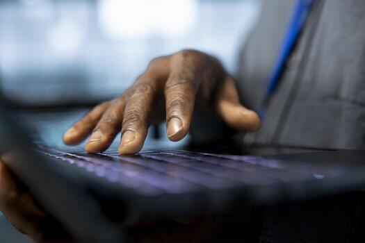 Admin in data center uses notebook to adjust power management settings, verifying compliance requirements. Close up of engineer in server room typing on laptop keyboard, optimizes resource utilization photo