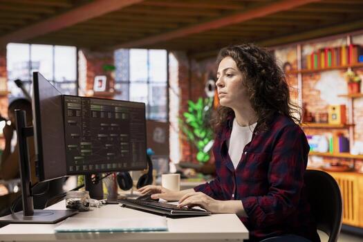 System administrator working in innovative startup office using programming languages to build application. Software development agency IT specialist optimizing code, typing on computer keyboard photo